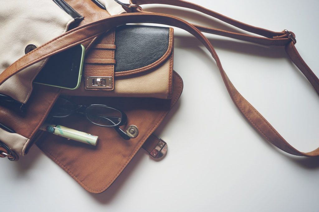 leather bag with glasses and pen inside it