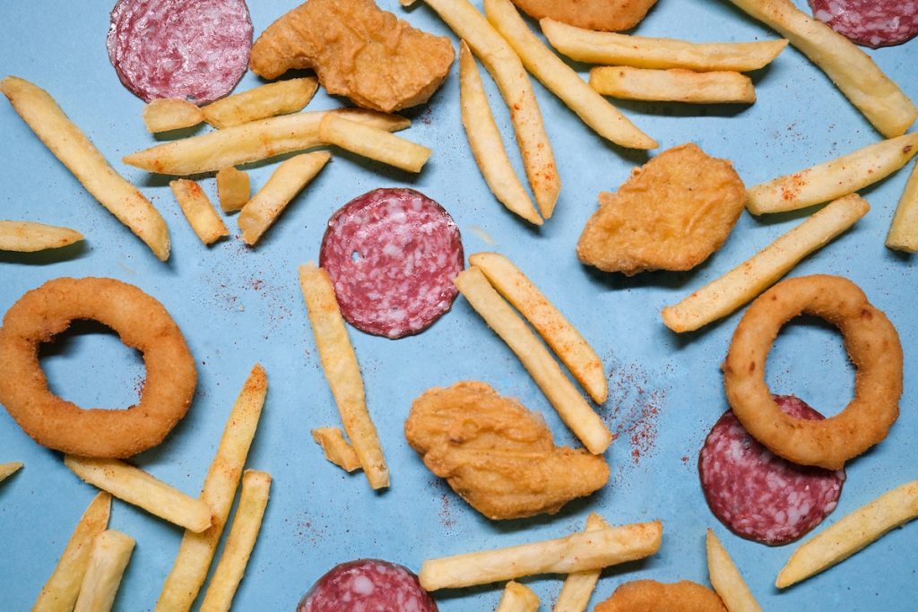 Salami with onion rings and nuggets near french fries